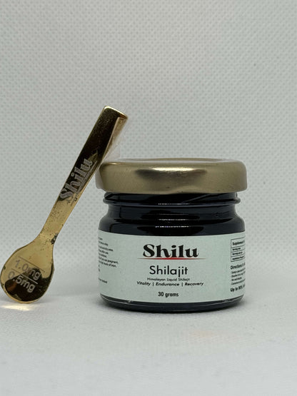 Jar of Shilu Shilajit nz with a gold spoon on a light gray background